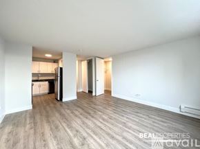 Chicago apartment for rent - A white bathroom with a walk in shower and a white towel rack.