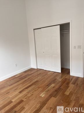 Paterson apartment for rent - A room with a white door and wooden flooring.