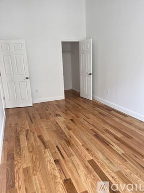 Paterson apartment for rent - A room with wooden flooring and two white doors.