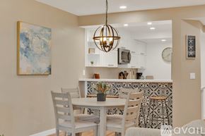 San Diego condo for rent - A dining room with a table set for two and a painting on the wall.
