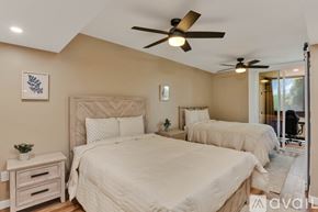 San Diego condo for rent - A bedroom with two beds and a ceiling fan.