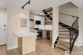 Chicago apartment for rent - A kitchen with a staircase leading to the upper floor.