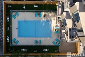 Chicago apartment for rent - An aerial view of a swimming pool surrounded by lounge chairs and umbrellas.