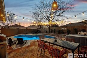Desoto house for rent - A backyard with a pool and a table set for dining.