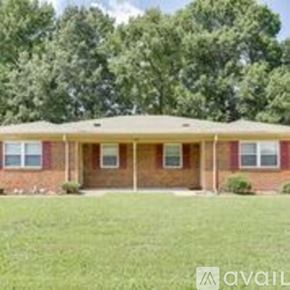 Suffolk apartment for rent - A house with a red brick exterior and a covered porch.
