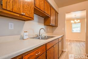 Suffolk apartment for rent - A kitchen with wooden cabinets and a sink.