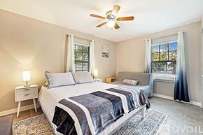 West Palm Beach apartment for rent - A bedroom with a large bed and a ceiling fan.