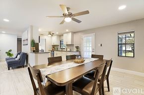 West Palm Beach apartment for rent - A dining room with a wooden table and chairs.
