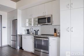 Milwaukee apartment for rent - A kitchen with white cabinets and stainless steel appliances.