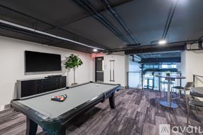Milwaukee apartment for rent - A room with a pool table and a television mounted on the wall.