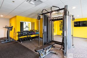 Milwaukee apartment for rent - A gym with a yellow wall and a variety of equipment.