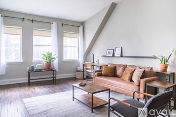 Milwaukee apartment for rent - A living room with a brown couch and a coffee table.