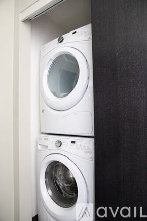 Milwaukee apartment for rent - Two white washing machines in a small space.