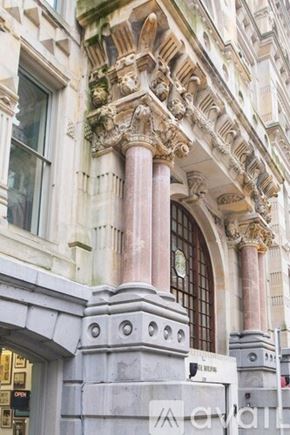 Milwaukee apartment for rent - A building with a large arched doorway and a clock on the wall.