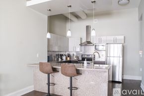 Milwaukee apartment for rent - A kitchen with a marble countertop and stainless steel appliances.