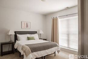 Milwaukee apartment for rent - A bedroom with a large bed and a painting on the wall.
