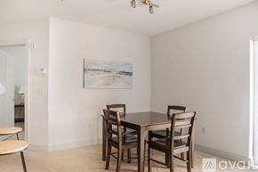 Milwaukee apartment for rent - A dining room with a table and chairs and a painting on the wall.