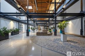 Milwaukee apartment for rent - A spacious atrium with a glass ceiling and a gravel pathway.