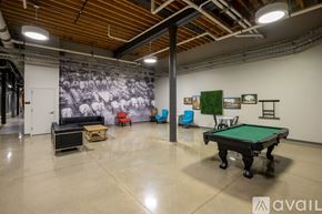 Milwaukee apartment for rent - A room with a pool table and a mural on the wall.