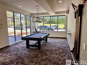 Milwaukee apartment for rent - A room with a pool table and a view of the street outside.