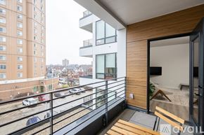 Milwaukee apartment for rent - A balcony with a view of a parking lot and buildings.