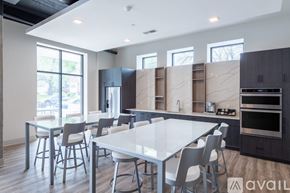 Milwaukee apartment for rent - A modern kitchen with a dining table and chairs.