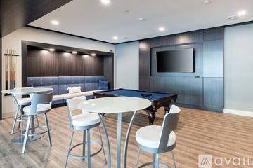 Milwaukee apartment for rent - A modern living room with a pool table and a television.