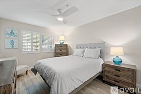 Oceanside apartment for rent - A bedroom with a bed, nightstand, and a ceiling fan.