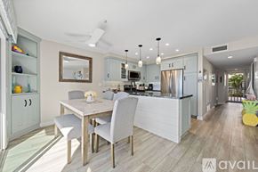 Oceanside apartment for rent - A modern kitchen with a dining table and chairs.