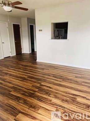 Greenville apartment for rent - A room with wooden floors and white walls.