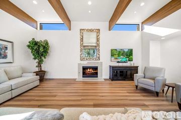 Palm Desert house for rent - A living room with a fireplace and a painting on the wall.