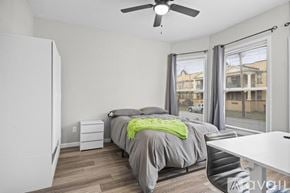Cleveland house for rent - A bedroom with a bed, desk, and chair.