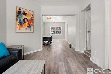 Cleveland house for rent - A living room with a couch, coffee table, and a painting on the wall.