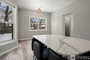 Cleveland house for rent - A dining room with a marble table and chairs.