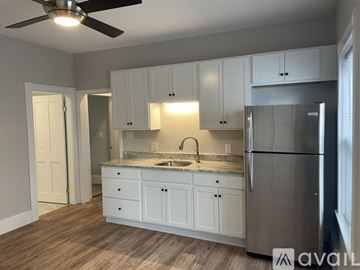 Worcester apartment for rent - A kitchen with white cabinets and a stainless steel refrigerator.