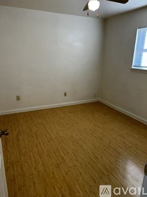 Kenner apartment for rent - A room with wooden flooring and a window with blinds.