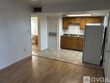 Kenner apartment for rent - A kitchen with wooden cabinets and a refrigerator.
