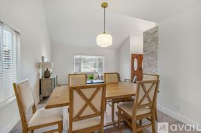 Huntington Beach house for rent - A dining room with a wooden table and chairs.