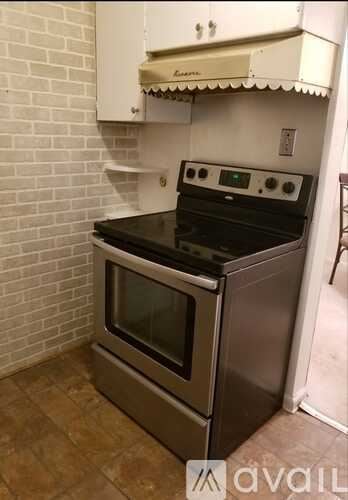 Detroit house for rent - A stainless steel oven with a digital display is in a kitchen.