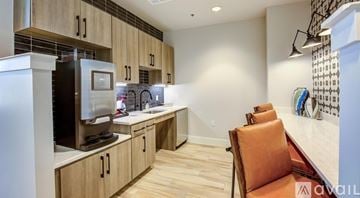 Frisco apartment for rent - A kitchen with wooden cabinets and a refrigerator.