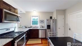 Providence apartment for rent - A kitchen with a black countertop and stainless steel appliances.