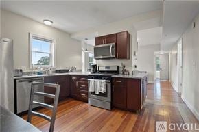 Providence apartment for rent - A living room with a television, a bicycle, and a coffee table.