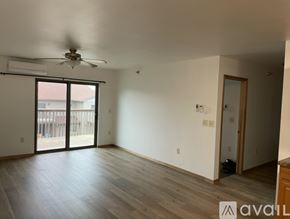 Galesville apartment for rent - A room with a ceiling fan and sliding glass doors.