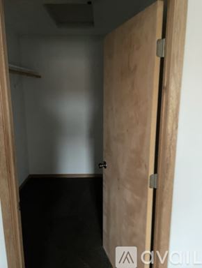 Galesville apartment for rent - A wooden door is open to a dark room.