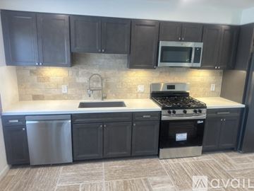 Fallbrook apartment for rent - A kitchen with dark brown cabinets and a stainless steel dishwasher.