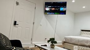 Tarzana house for rent - A living room with a flat screen TV mounted on the wall.