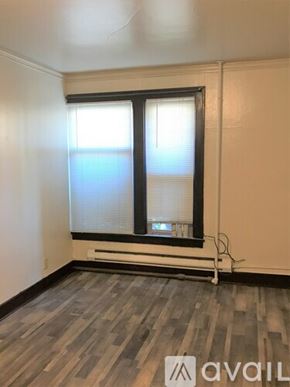 Seattle apartment for rent - A room with a window and a wooden floor.