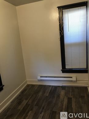 Seattle apartment for rent - A room with a window and a radiator on the floor.