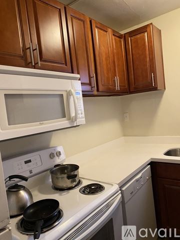 Seattle apartment for rent - A kitchen with a white stove top and a white microwave above it.