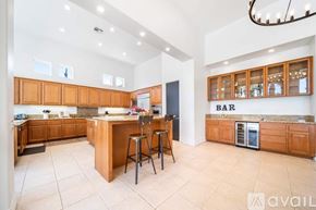 La Quinta house for rent - A kitchen with wooden cabinets and a bar area.